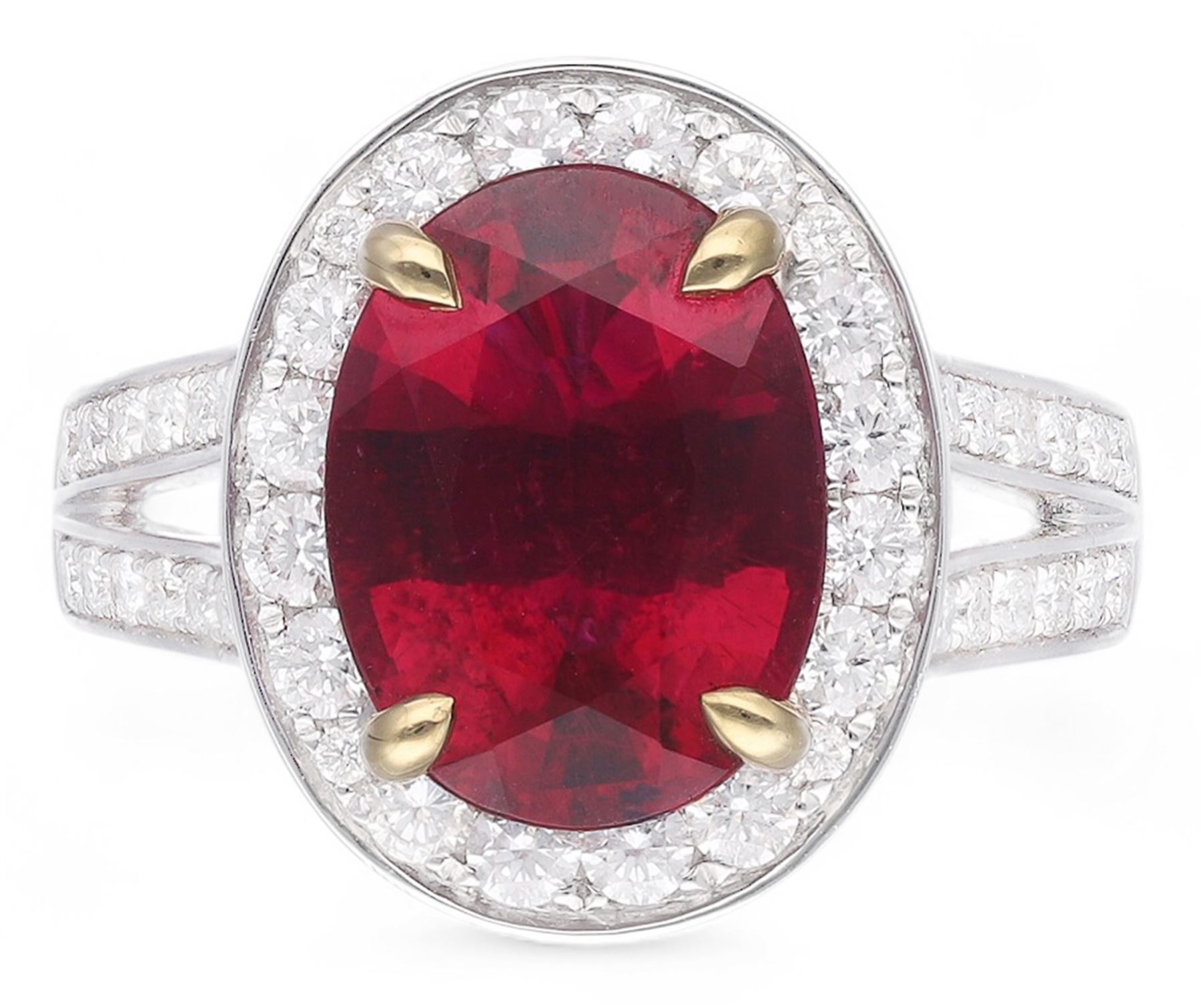 18ct white gold oval cut rubellite tourmaline and round brilliant cut diamond cluster ring, with diamond set shoulders, hallmarked, rubellite 3.93 carat, total diamond weight 0.86 carat 