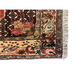 Kurdish rose ground runner rug, set with a series of ten floral medallions on linked field, the border decorated with stylised flower heads and bird motifs 