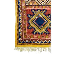 Persian Qashqai crimson ground rug, the field with central indigo and yellow medallion with geometric motifs, flanked by smaller medallions, border with repeating patterns (112cm x 200cm); Turkish Kazak light blue ground rug (109cm x 193cm); red ground runner with three octagonal medallions (69cm x 138cm)