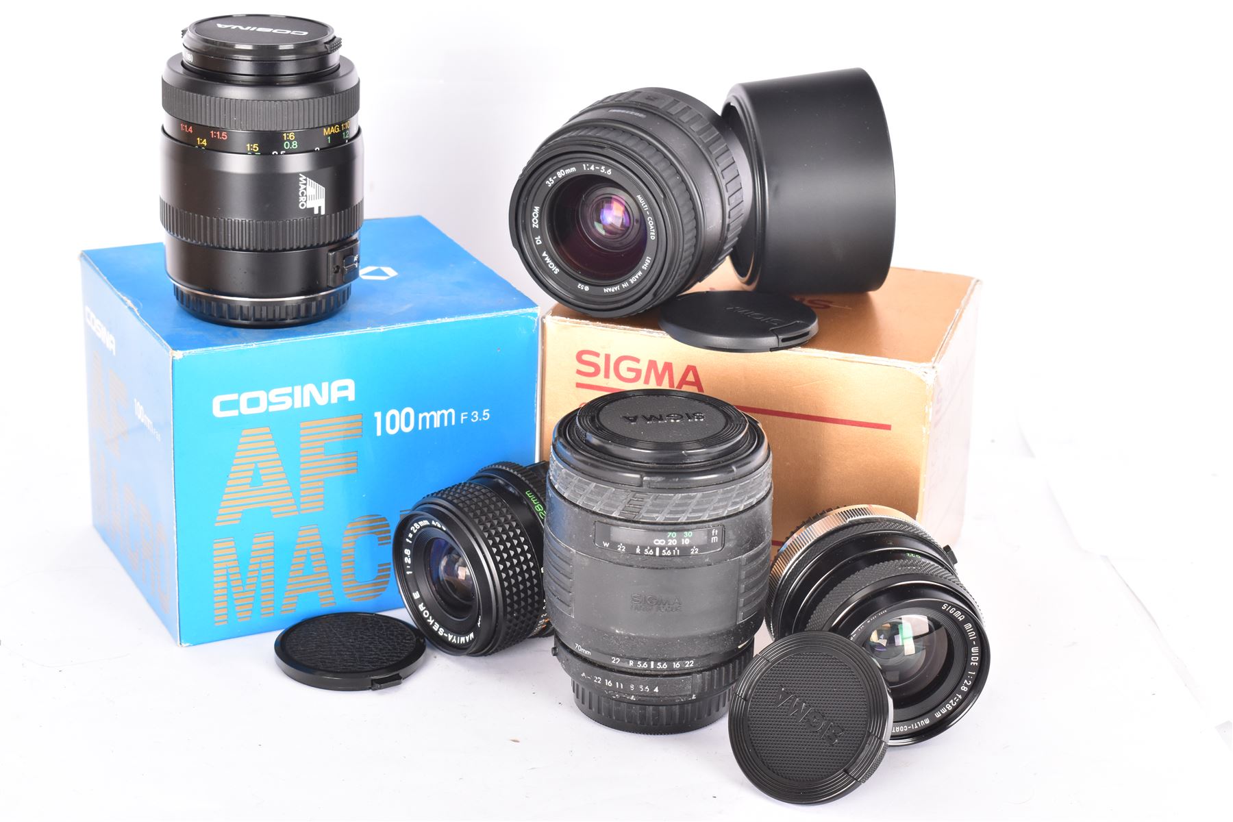 Group of camera lenses, comprising Cosina 100mm 1:3.5 MC Macro lens serial no. 9924159, Sigma DL Zoom 35-80mm 1:4-5.6 serial no 2031995, both boxed, Sigma UC Zoom 70-210mm 1:4-5.6 lens serial no. 1014147 and a Sigma Mini-Wide 1:2.8 f=28mm lens serial no. 261735, etc