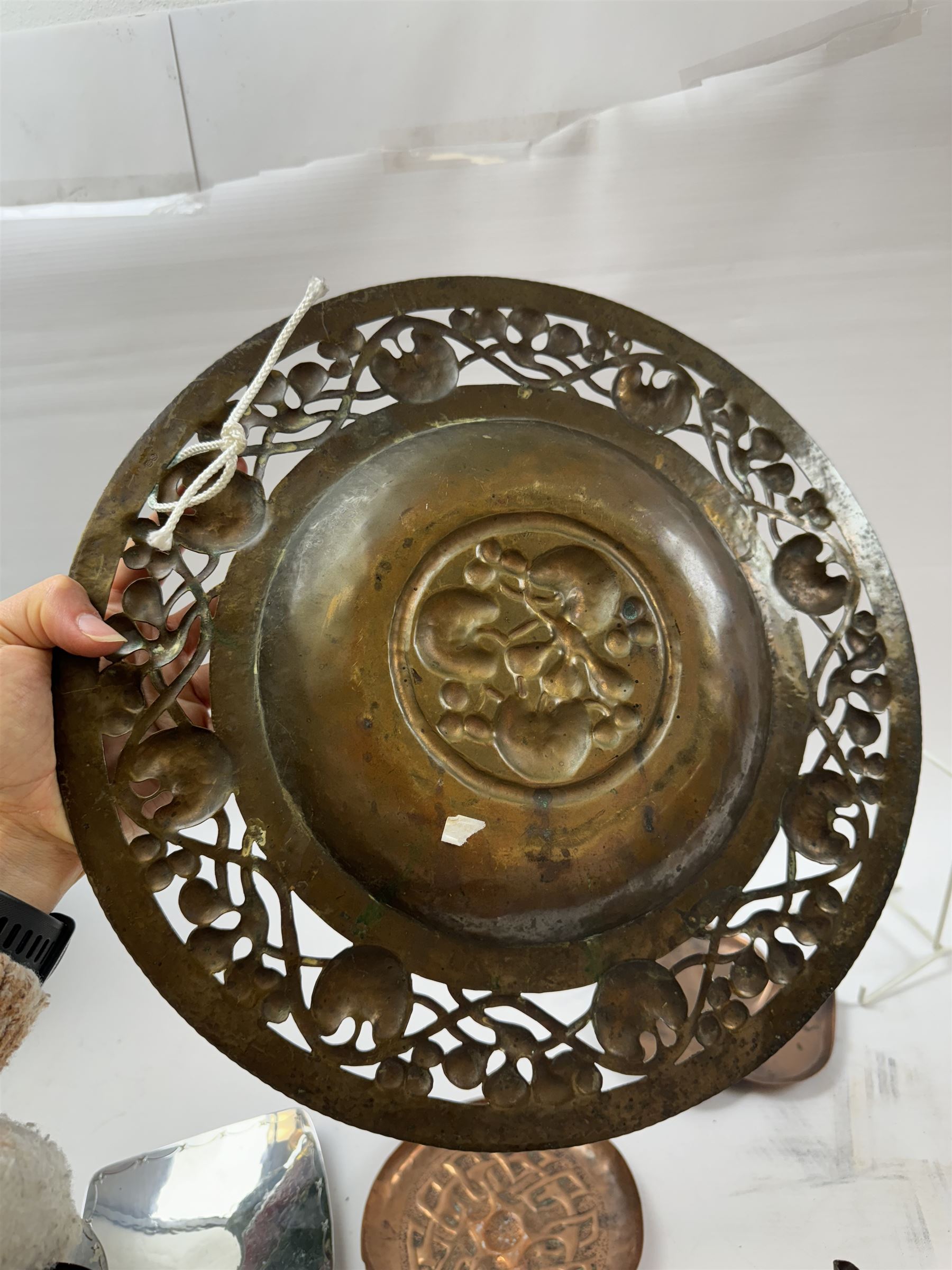 Keswick School of Industrial Arts, flared vase of cylindrical form, together with an Arts and Crafts plated copper, an embossed tray, copper dishes and charger 