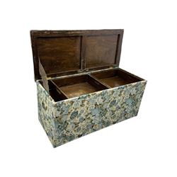 Mid 20th century oak blanket box, upholstered in floral pattern fabric, padded hinged lid enclosing oak interior with two removable trays, brass side handles, on round metal supports