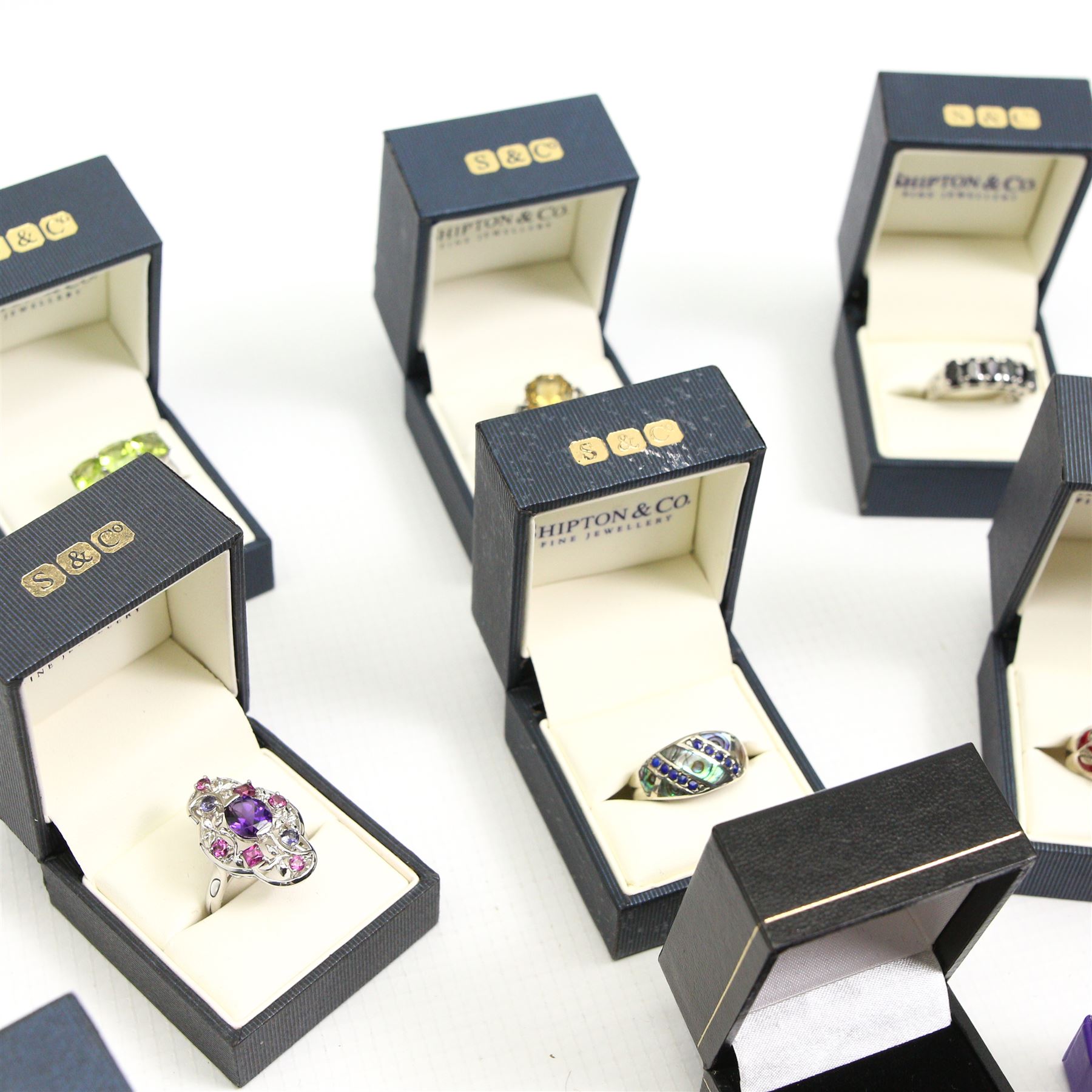 Twelve silver gemset rings, including a jet ring with Celtic design shoulders and a garnet two row cluster ring, amethyst cluster ring and an early 20th century citrine ring