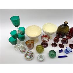 A group of Victorian glassware, to include Ruby flashed decanter and six glasses, decanter H25cm, five further drinking glasses with green bowls, a dump paperweight, and miniature painted milk glass teawares, two slag glass pedestal bowls, four slag glass tumblers, plus a small selection of later glassware, comprising a moulded glass bottle detailed 'Success to the Railroad', and an amber glass Isle of Man 1892 exhibition compressed tumbler. 
