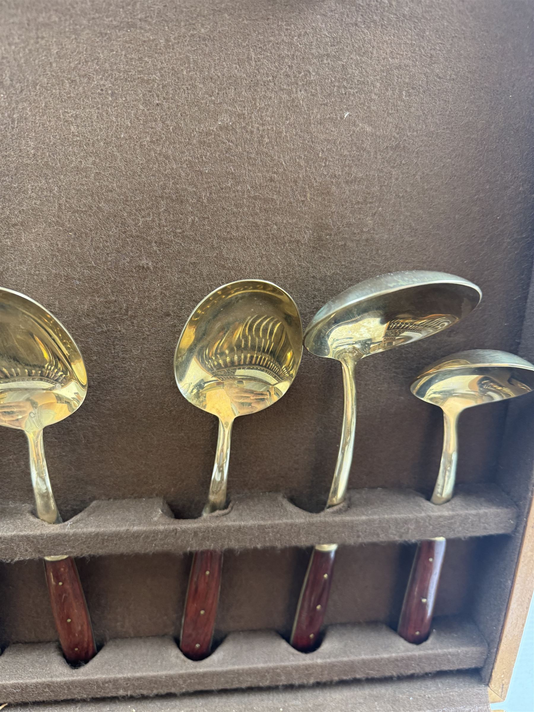 Wooden cased six place Thai gilt metal canteen of cutlery, together with additional matching flatware 