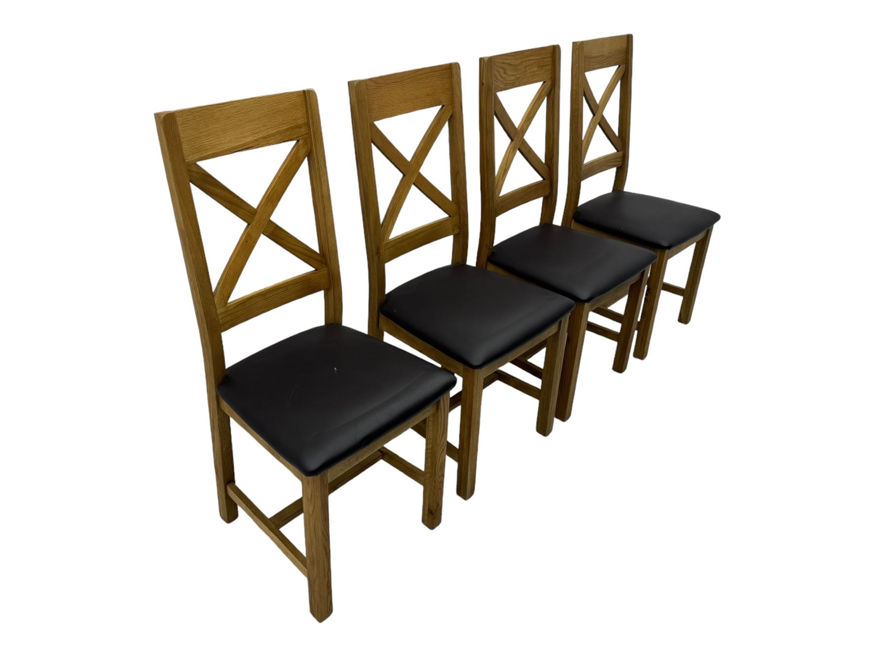 Oak extending dining table, square pull-out action top with folding butterfly leaf, on straight square supports; set of four dining chairs, X-shaped backrest and black upholstered seat, on square supports united by H-stretcher