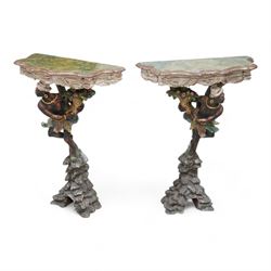 Pair of Venetian 18th century design figural polychrome painted console or torchère tables, green marbled demi-lune top with moulded scalloped edge, over a carved frieze in the form of white swags, the figural pedestal bearing a cornucopia, and dressed in a white turban and ostrich feather skirt over a down-scrolling acanthus support, standing upon a naturalistic rock carved base