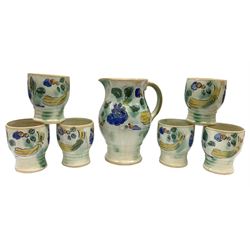 Early 20th century Royal Doulton Brangwyn Ware jug and set of six beakers, designed by Frank Brangwyn RA, all decorated in the Harvest pattern with stylised leaves and fruit on mottled peach and green ground, all with printed marks beneath, date code for 1920s, largest H18cm