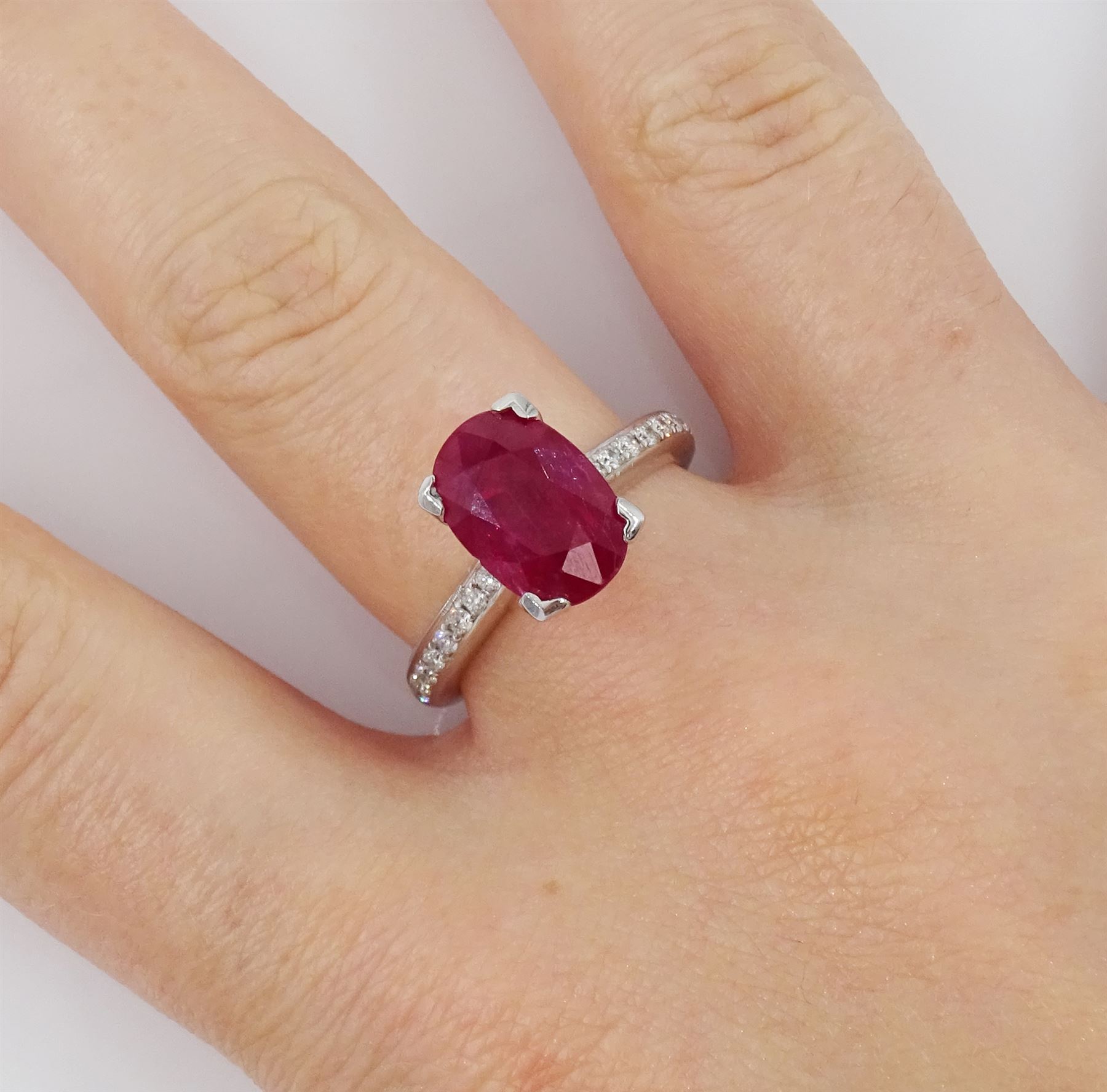 18ct white gold oval cut ruby ring, with channel set diamond shoulders, hallmarked, ruby approx 2.75 carat