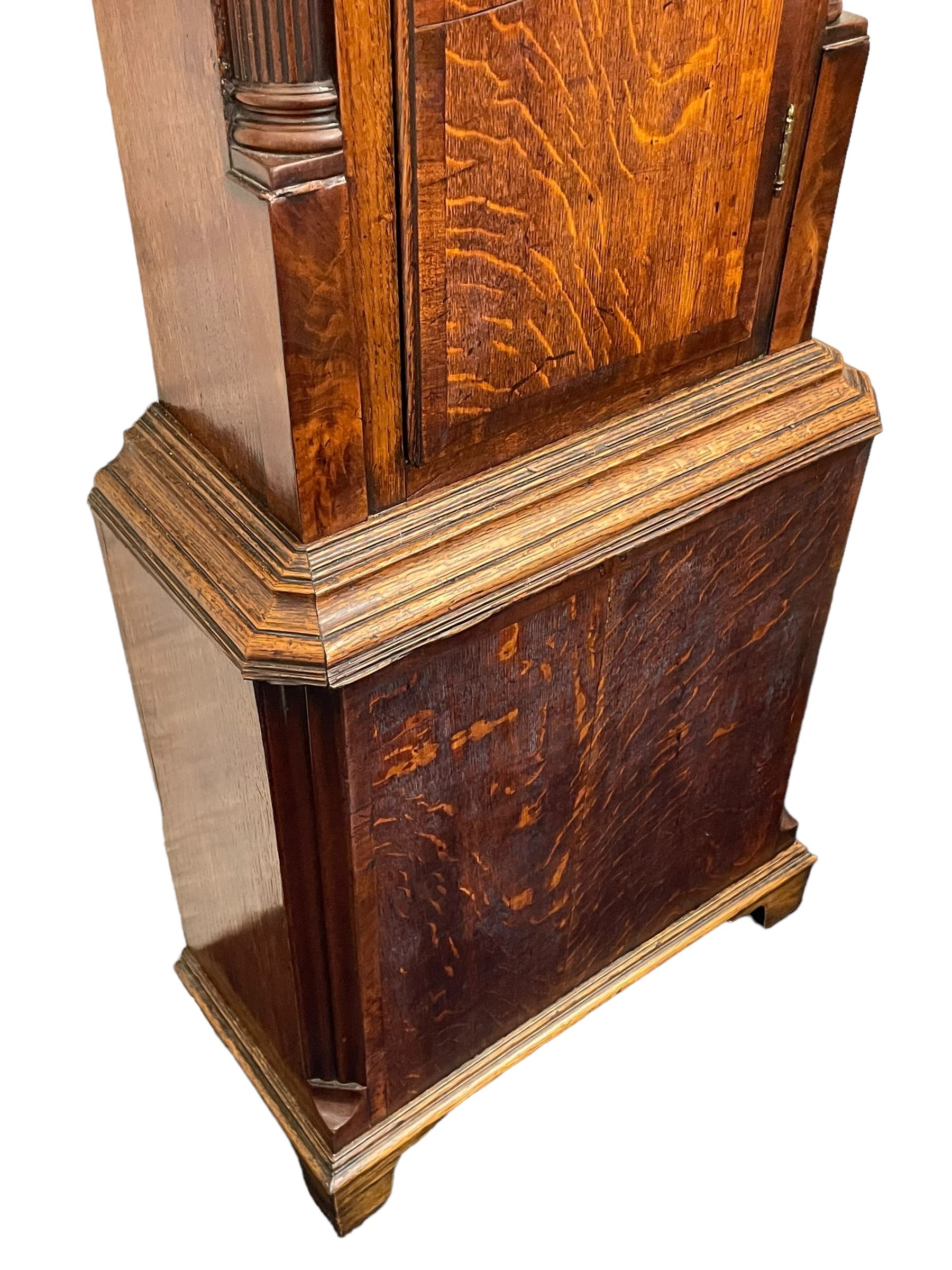 William Watson of  Blackburn (Lancs)  - late 18th century 8-day oak and mahogany cross banded longcase clock, with a flat top and open fretwork above, deep cornice with dogtooth moulding and frieze beneath, square hood door flanked by reeded pilasters with brass capitals, trunk with  reeded quarter columns, long trunk door with concave corners on a plinth with canted corners on bracket feet, brass dial with cast brass spandrels, broad silvered chapter ring with Roman numerals and five-minute Arabic's, a profusely engraved and silvered dial centre with seconds dial, matching steel hands and calendar aperture, hourly rack striking movement with a recoil anchor escapement. With weights, pendulum and key. 
William Watson of Northgate, Blackburn, is recorded as working c1770-1814 . As with this clock he frequently signed some of his clocks without a placename.