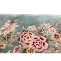 Chinese pale turquoise ground washed woolen rug, the plain field decorated with two large floral bouquet motifs with extending blossom and leafage