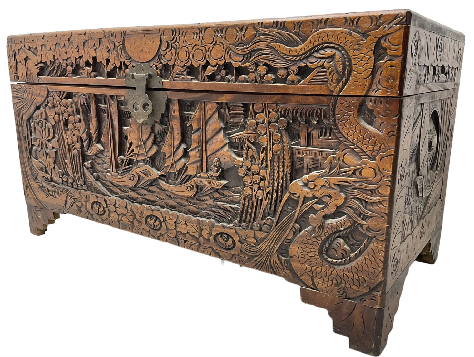 Chinese carved camphor wood blanked chest, rectangular hinged top, carved all over with traditional dragon motifs and junk ships