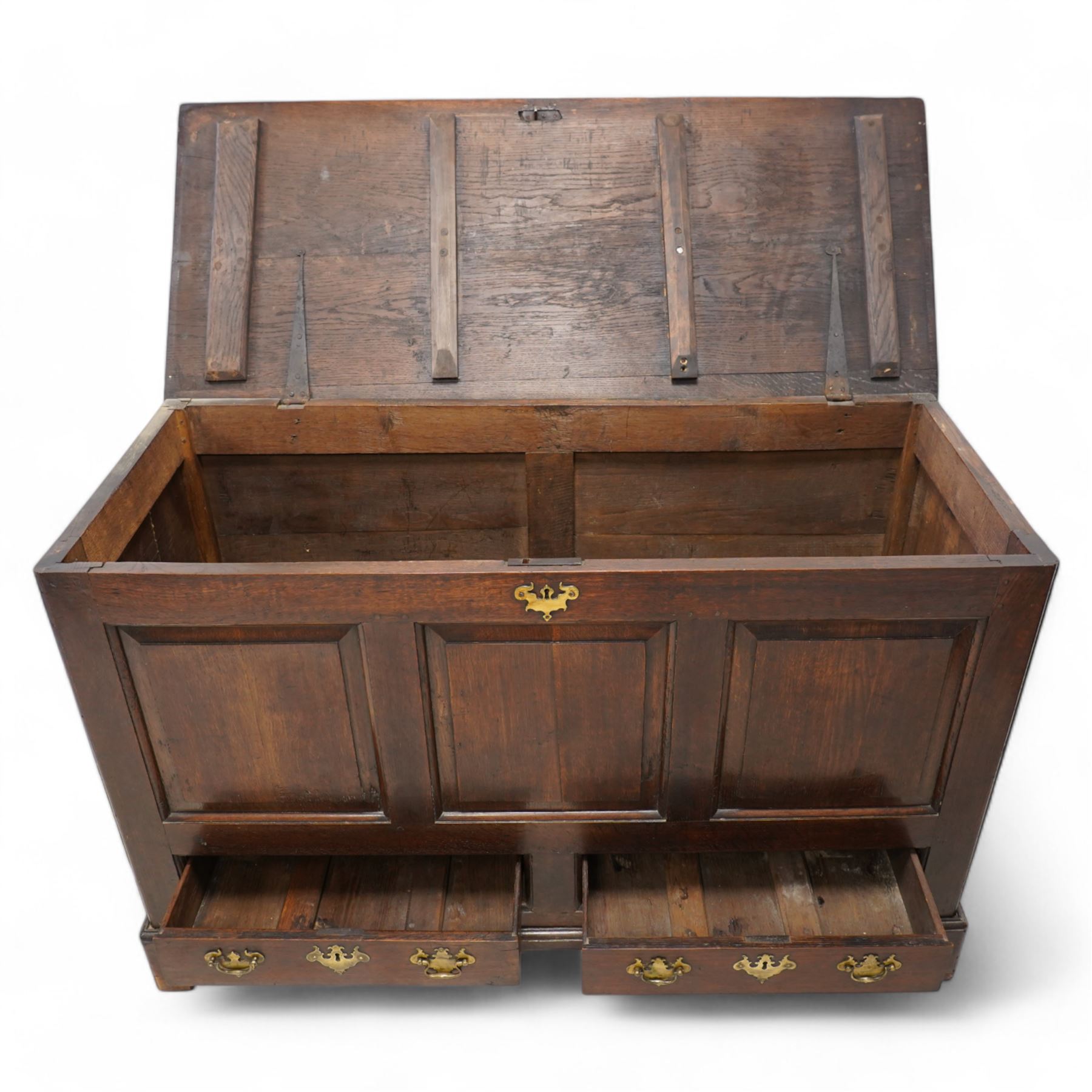 18th century oak mule chest, rectangular hinged top enclosing main compartment, over a triple fielded panelled front, two drawers fitted to base, lower moulded edge on shaped bracket feet