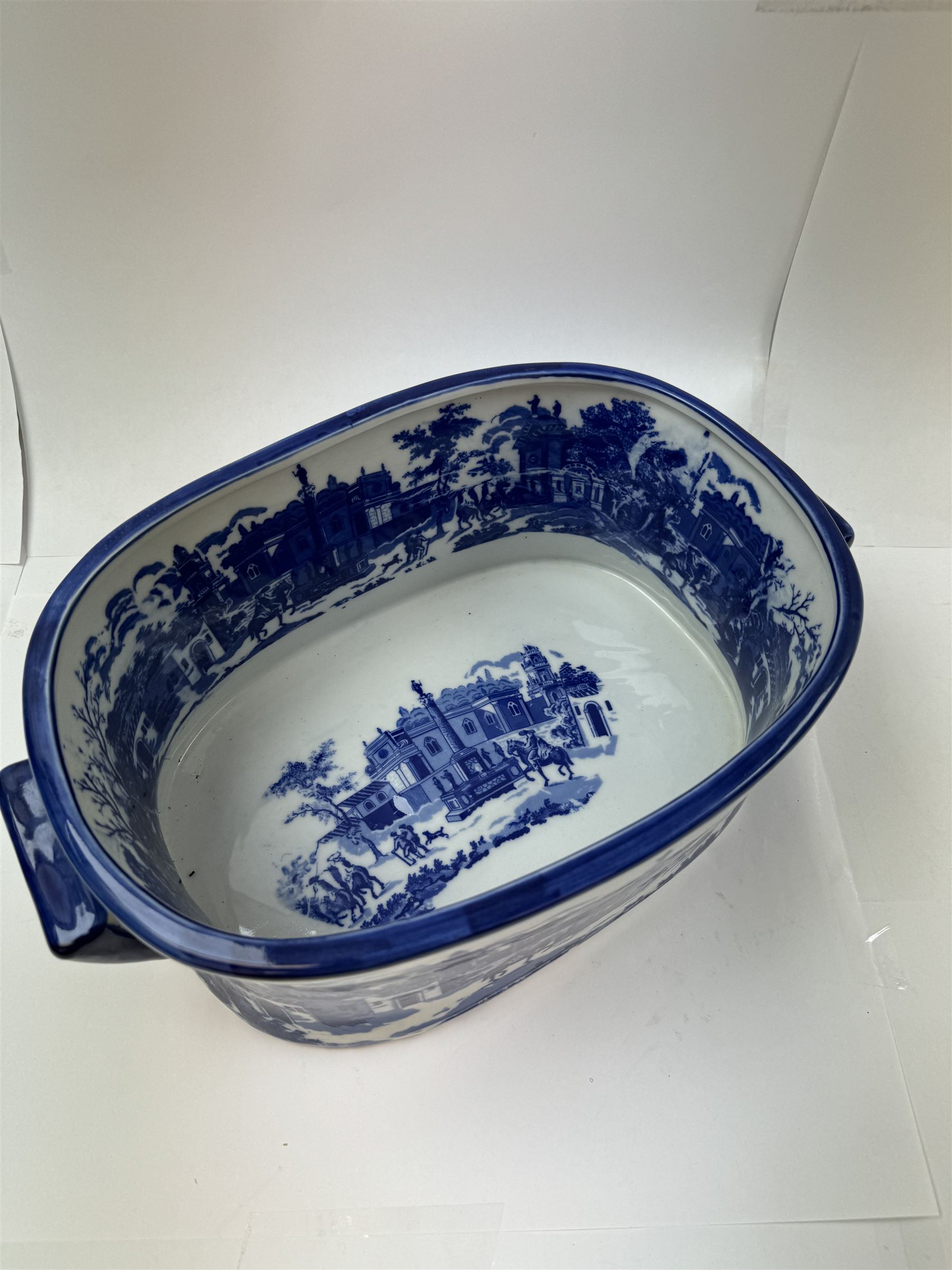 Pair of Victorian style blue and white footbaths, each with twin lug handles and transfer print decorated with city scape, H14cm