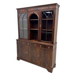 Georgian design mahogany bookcase on cupboard, projecting moulded and dentil cornice, two display cabinets enclosed by glazed doors above over three drawers and three cupboards, on bracket feet