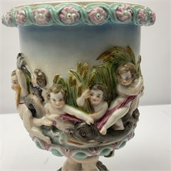 Early 20th century continental pedestal jar with cover, the bowl held aloft by four mermaids and decorated with putti playing instruments in a lake, the fluted domed cover topped with cherub playing a horn, H38cm