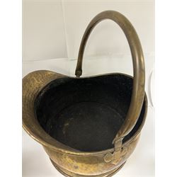 Middle eastern copper bucket, with chased and embossed band of animal decoration, together with a copper jardinière embossed with floral panels, copper plate with embossed leaf motif and two brass helmet shaped coal scuttles, bucket H26cm