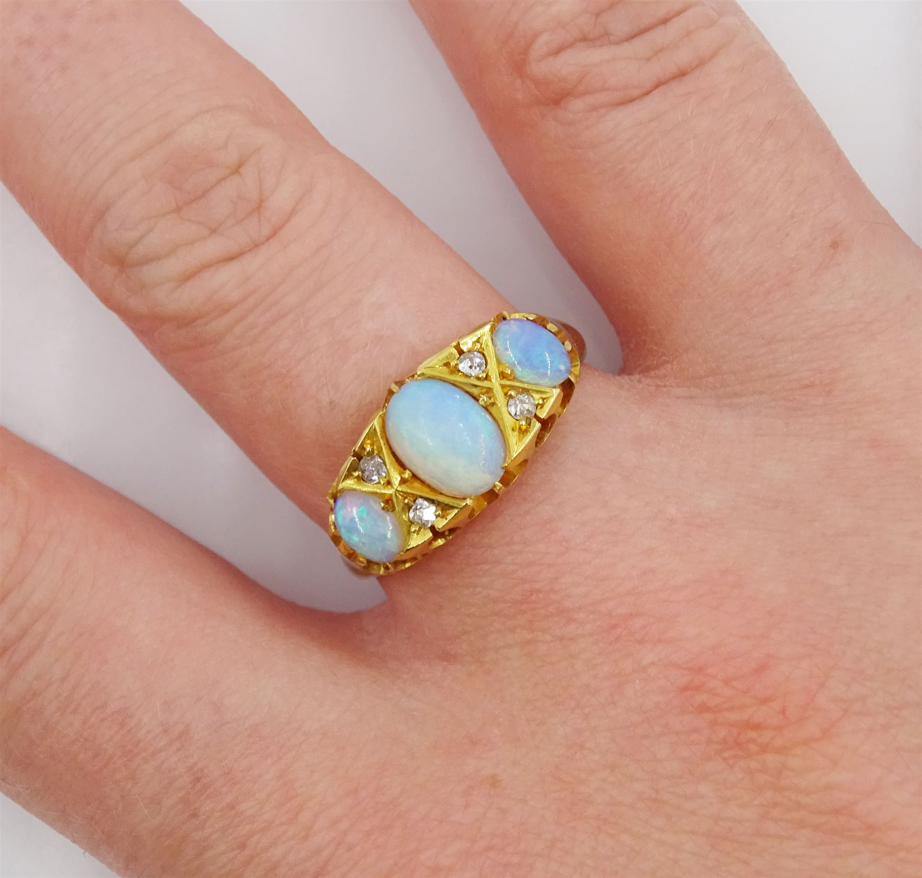 Victorian 18ct gold three stone opal ring, with four diamond accents set between