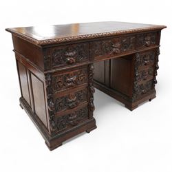 Victorian carved oak twin pedestal desk, moulded and foliate carved rectangular top with l...