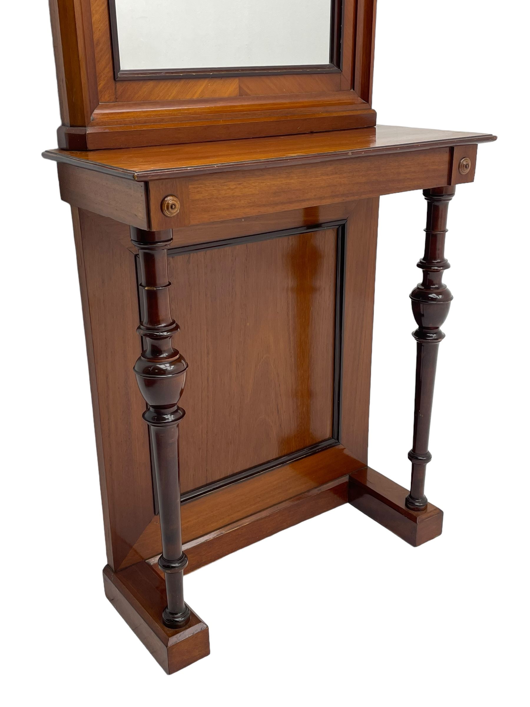 Late 19th to early 20th century walnut hallway console table with pier mirror, tall rectangular mirror with ovolo-moulded cornice, plain mirror plate surrounded by moulded slip and crossbanding, rectangular top over panelled back supports by turned supports, on sledge feet 