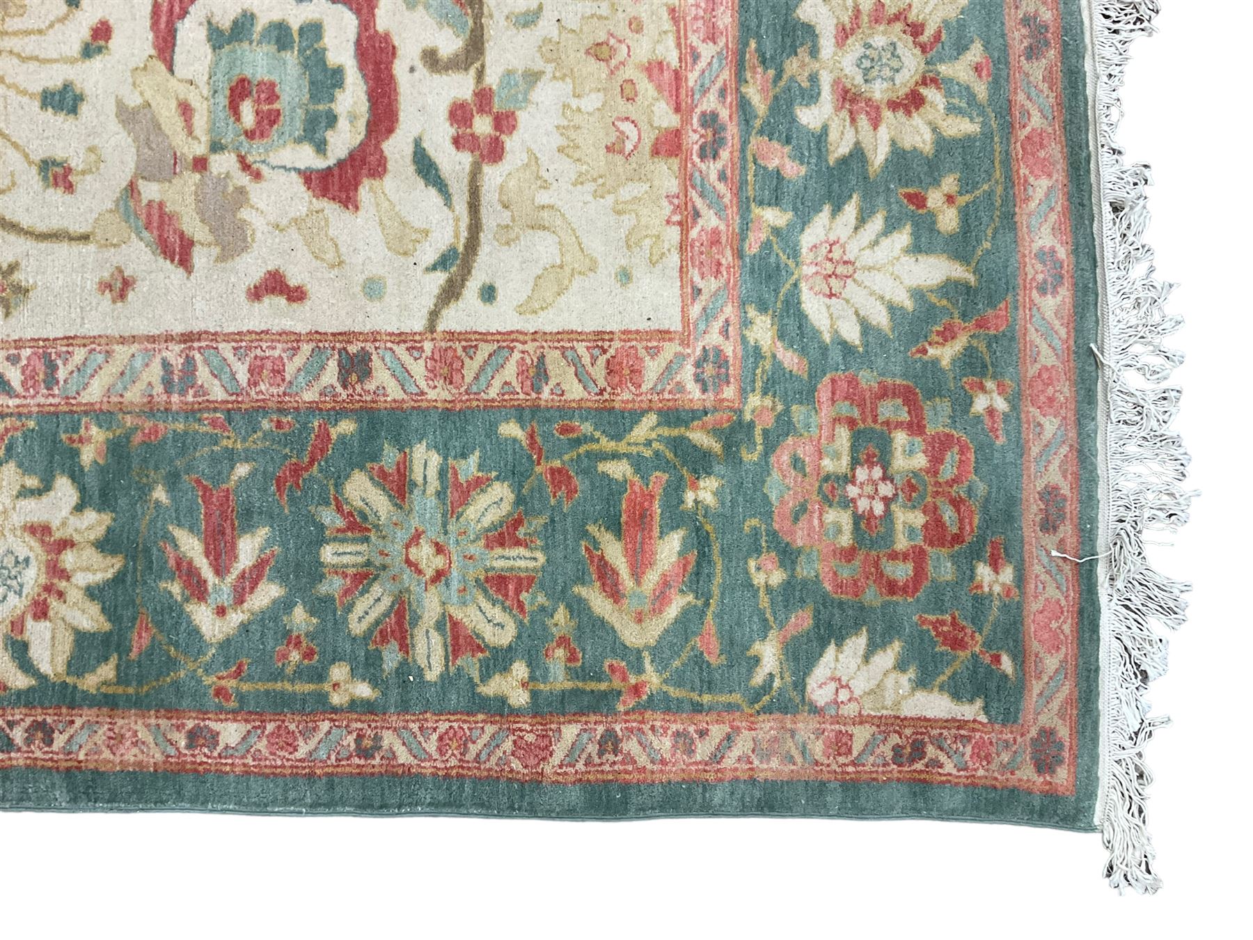 Persian Ziegler design carpet, pale ground field decorated with large stylised plant motifs, the border decorated with large floral motifs within repeating guards