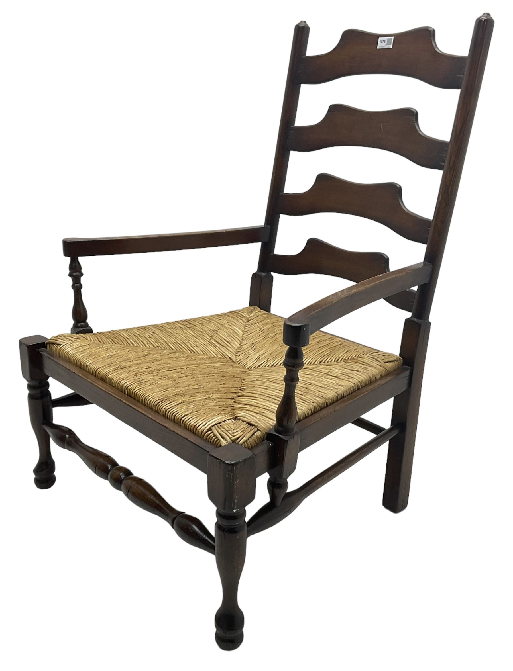 Georgian design oak country low armchair, waived ladder back over rush seat, raised on turned  supports united by stretchers; together with matching stool