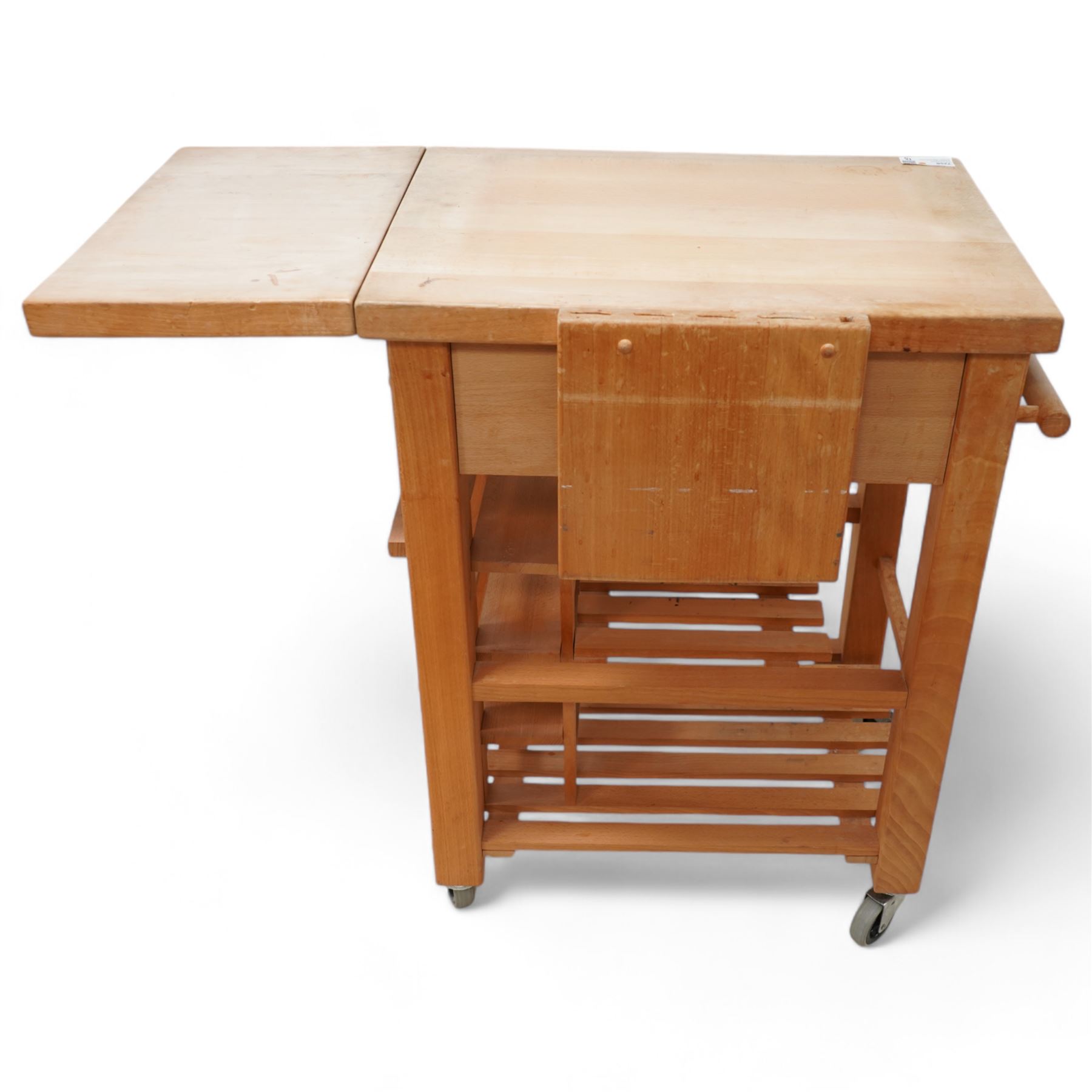 Late 20th century beech kitchen preparation trolley, rectangular drop-leaf butcher's block top, fitted with single drawer and knife slots, over two slatted tiers, on castors