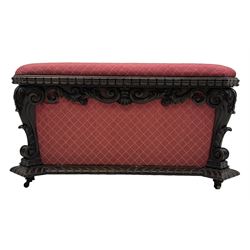 19th century rosewood and simulated rosewood ottoman footstool, tapering canted rectangular form enclosed by hinged lid, upholstered in red fabric, the frieze decorated with scrolling leaves, each corner with scrolled acanthus leaf supports, projecting shallow gadroon moulded edge 