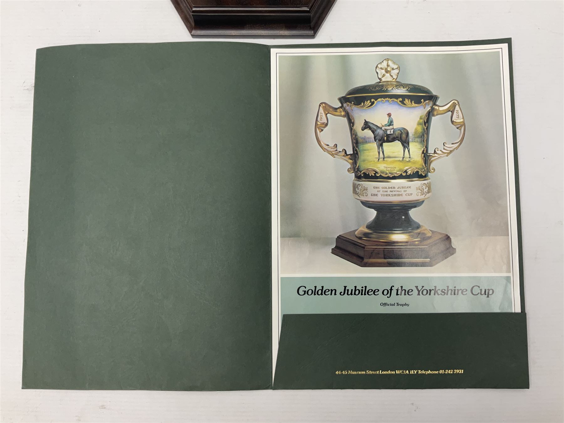 Aynsley twin handled racing cup and cover, to commemorate 'The Golden Jubilee of the Revival of The Yorkshire Cup', the handles inscribed '1927' and '1977', the green body painted by E. Woodhouse with Joe Childs up on Trimdon, the reverse with the winners, the domed cover with a Yorkshire rose finial, limited edition no. 4 of 50, on hexagonal wooden base with certificate, H34cm