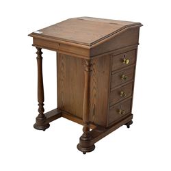 19th century pitch pine Davenport desk, sloping hinged top, fitted with four drawers, on turned column supports, turned compressed feet with castors 