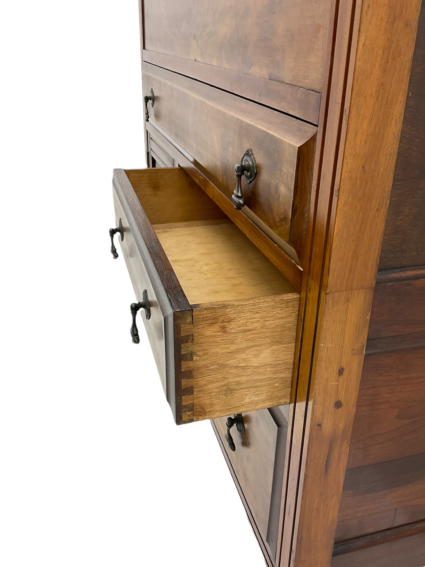 Edwardian walnut gentleman's tallboy, moulded hinged lid enclosing divisions, long drawer over two short drawers and panelled cupboard, turned supports terminating at ceramic castors