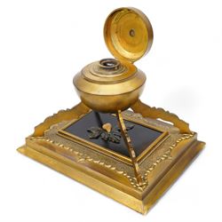 19th century gilt brass inkstand, of circular form, the hinged cover decorated with hardstone fruit and foliage upon a black ground, opening to reveal ink recess, upon four raised feet with a stepped square base, decorated with engraved foliate boarder, the black central panel with similar hardstone decoration H16cm; together with a pair of Chevalier of Paris opera glasses and a cast metal sculpture of a hunting dog (3)