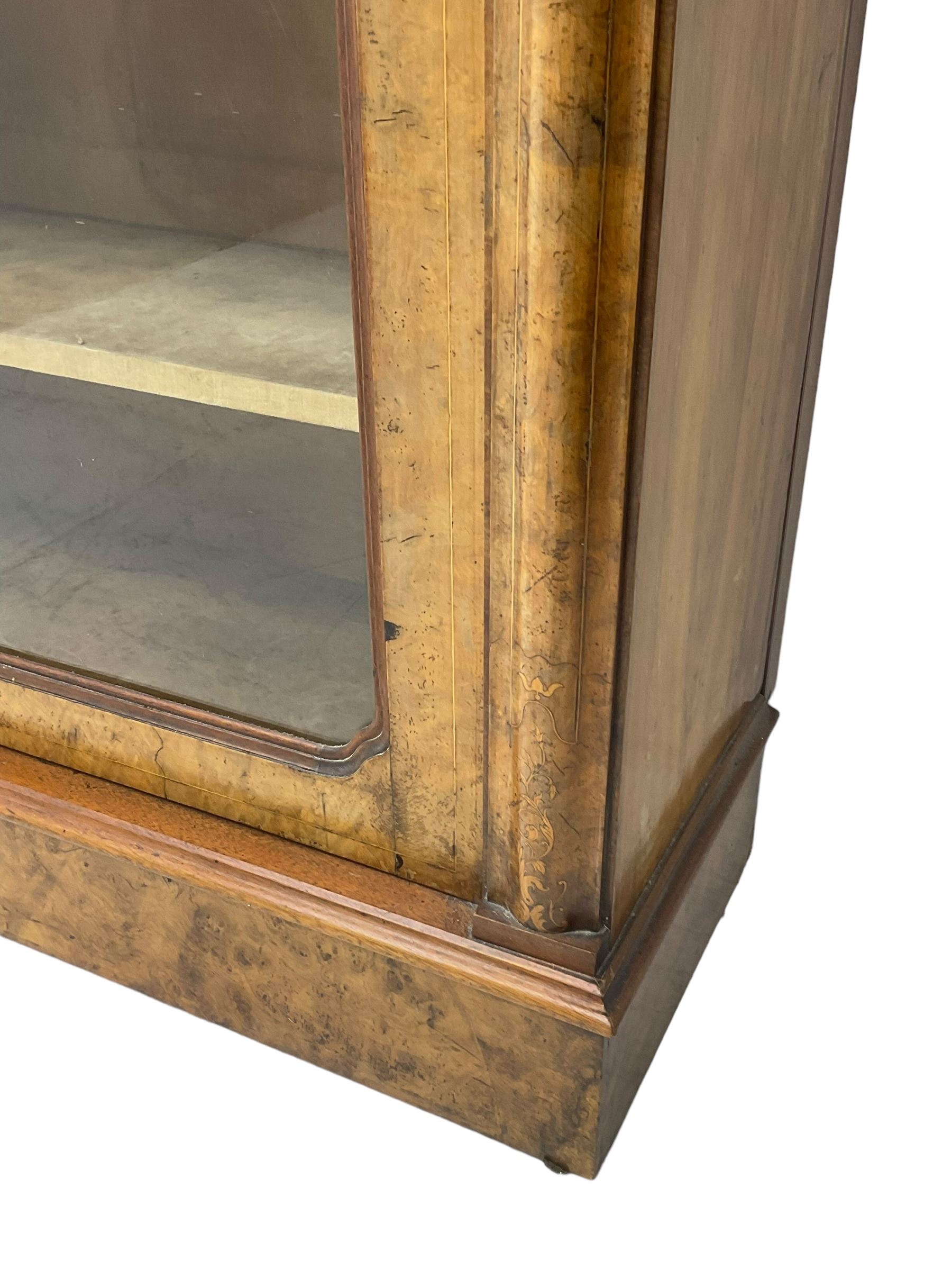 Victorian inlaid walnut pier display cabinet, moulded rectangular top over cavetto frieze, the moulded upright inlaid with scrolling foliage, fabric lined interior fitted with two shelves enclosed by single glazed door, on moulded plinth base 