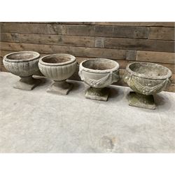 Pair of circular cast stone circular planters, and a similar pair decorated with swags (4)