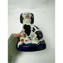 Pair of standing Staffordshire whippets with rabbits in their mouths, together with a pair of Staffordshire spaniels, whippets H30cm