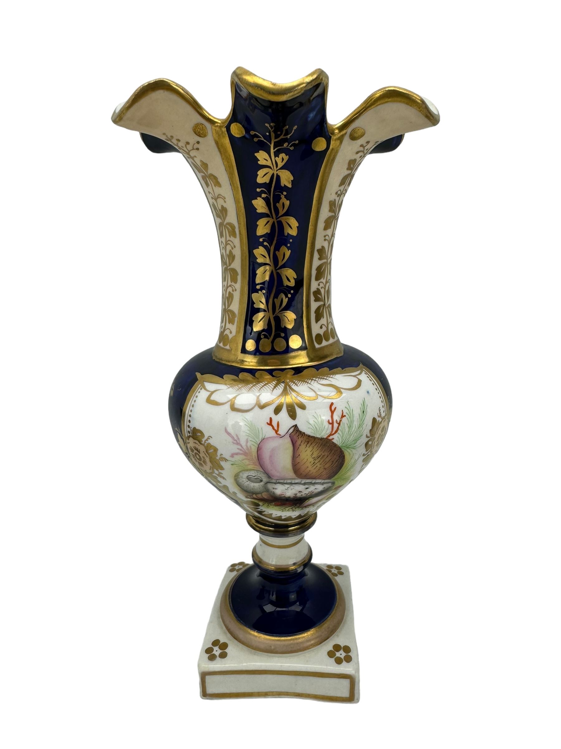 Samuel Alcock porcelain vase of footed two-handled form decorated with a panel of flowers and landscape verso, H16cm, 19th century porcelain vase with flared petal shaped rim, hand painted with a still life of shells, against a cobalt blue and gilt ground, small porcelain basket hand painted with a figure, and campana shaped urn (4)