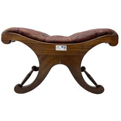 Late 20th century mahogany curved x-framed footstool, upholstered in buttoned red leather, splayed supports united by turned stretchers 