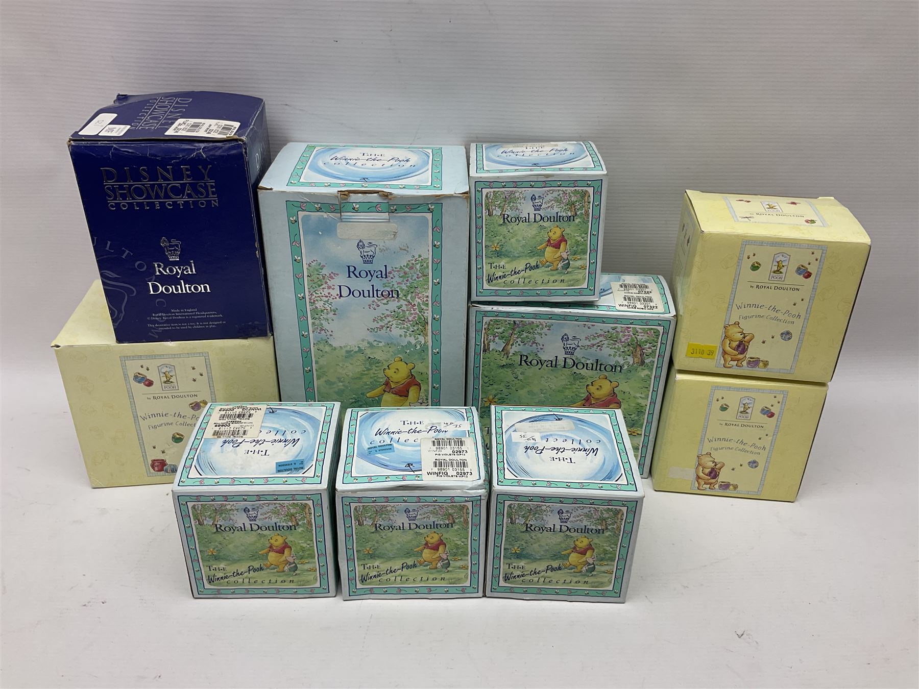 Nine Royal Doulton Winnie the Pooh Collection figures, including Oh Dear Bath Time's Here, Going Sledging, Tigger's Splash Time and Christopher Robin, together with a Royal Doulton Disney Showcase Jiminy Cricket figure, all boxed