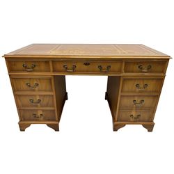 Georgian design yew wood twin pedestal desk, moulded rectangular top over nine cock-beaded drawers, on bracket feet