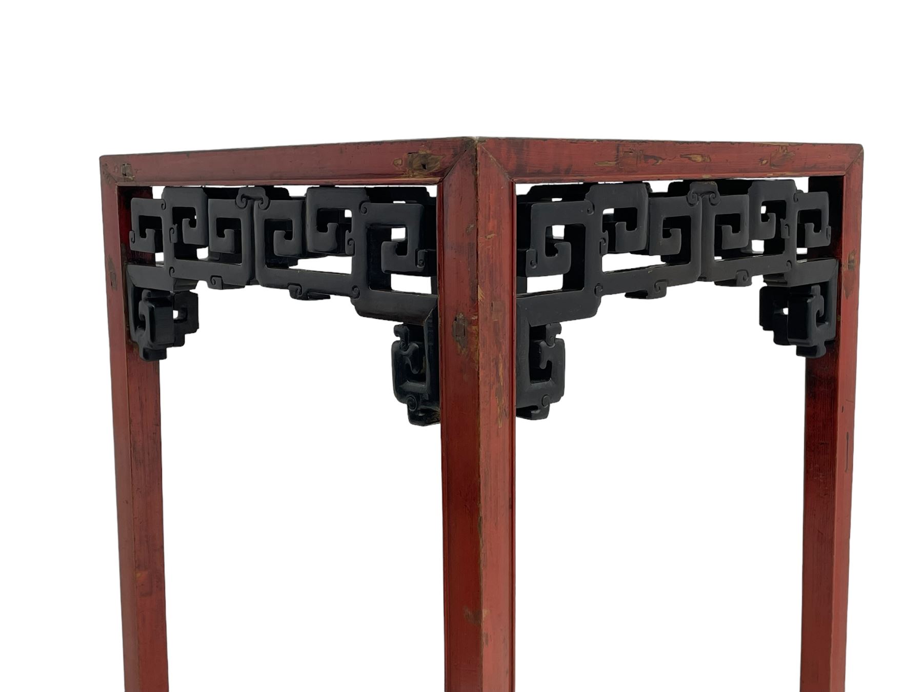 Late 19th century Chinese Qing dynasty red and black lacquered wood tall tea table, Shanxi region, square top over geometric scroll fretwork panels, on square supports with hoof feet 