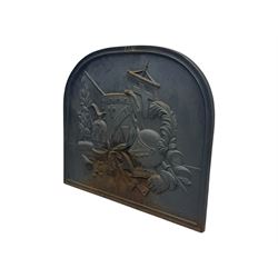 French cast iron fireback, arched form with relief of medieval armour and heraldic symbols, including a shield with a cross and a plumed helmet