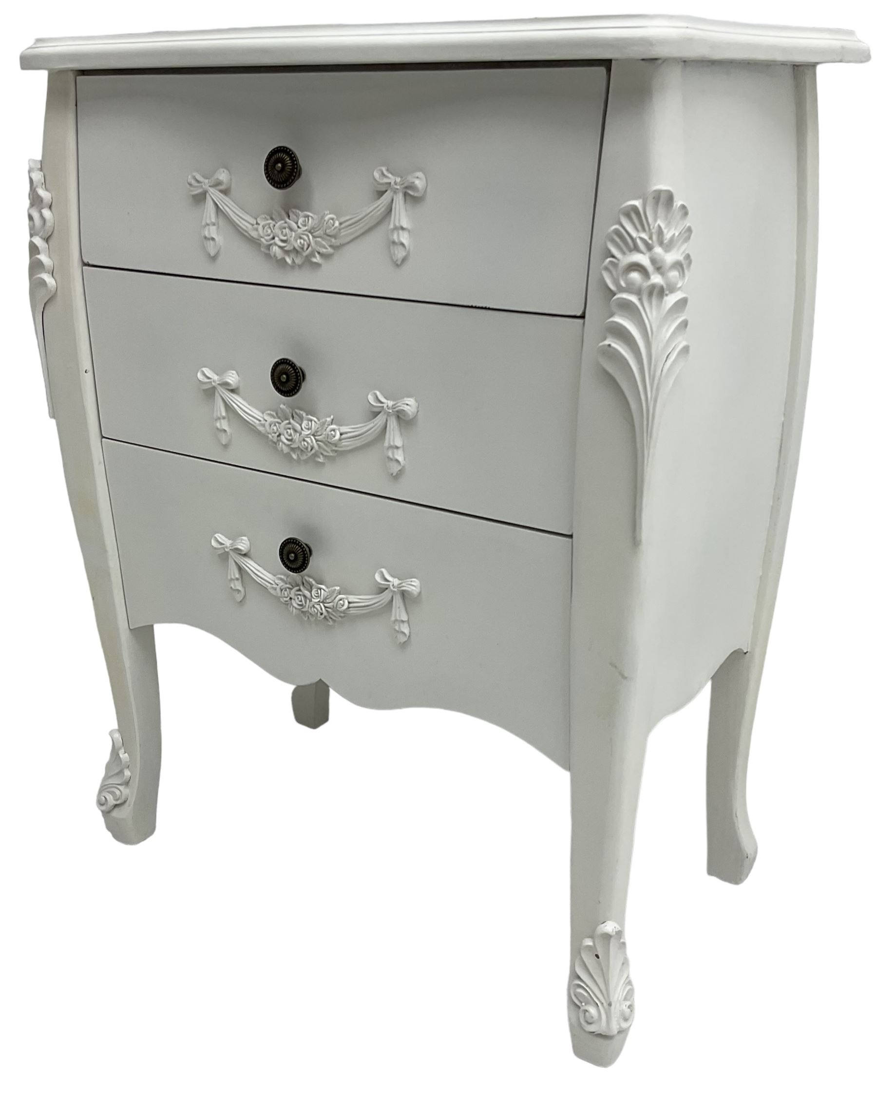 French design white painted chest, shaped top over three drawers, each with applied swags with flower heads, flanked by cabriole uprights with foliate mouldings