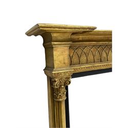 Regency design giltwood overmantel mirror, projecting cornice over pointed arcade frieze and foliate moulded upper edge, plain mirror plate within reed moulded ebonised slip, flanked by cluster columns with acanthus and scroll decorated Composite order capitals 