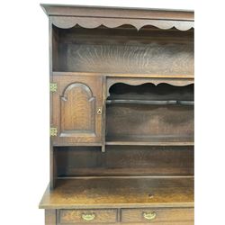 Early 20th century Georgian design oak dresser, projecting cornice with shaped apron over a three-tier plate rack with flanking fielded spice cupboards, the base fitted with three drawers, on turned supports