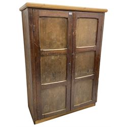 Victorian stained pine cupboard, fitted with two panelled doors with chamfered rails enclosing three shelves