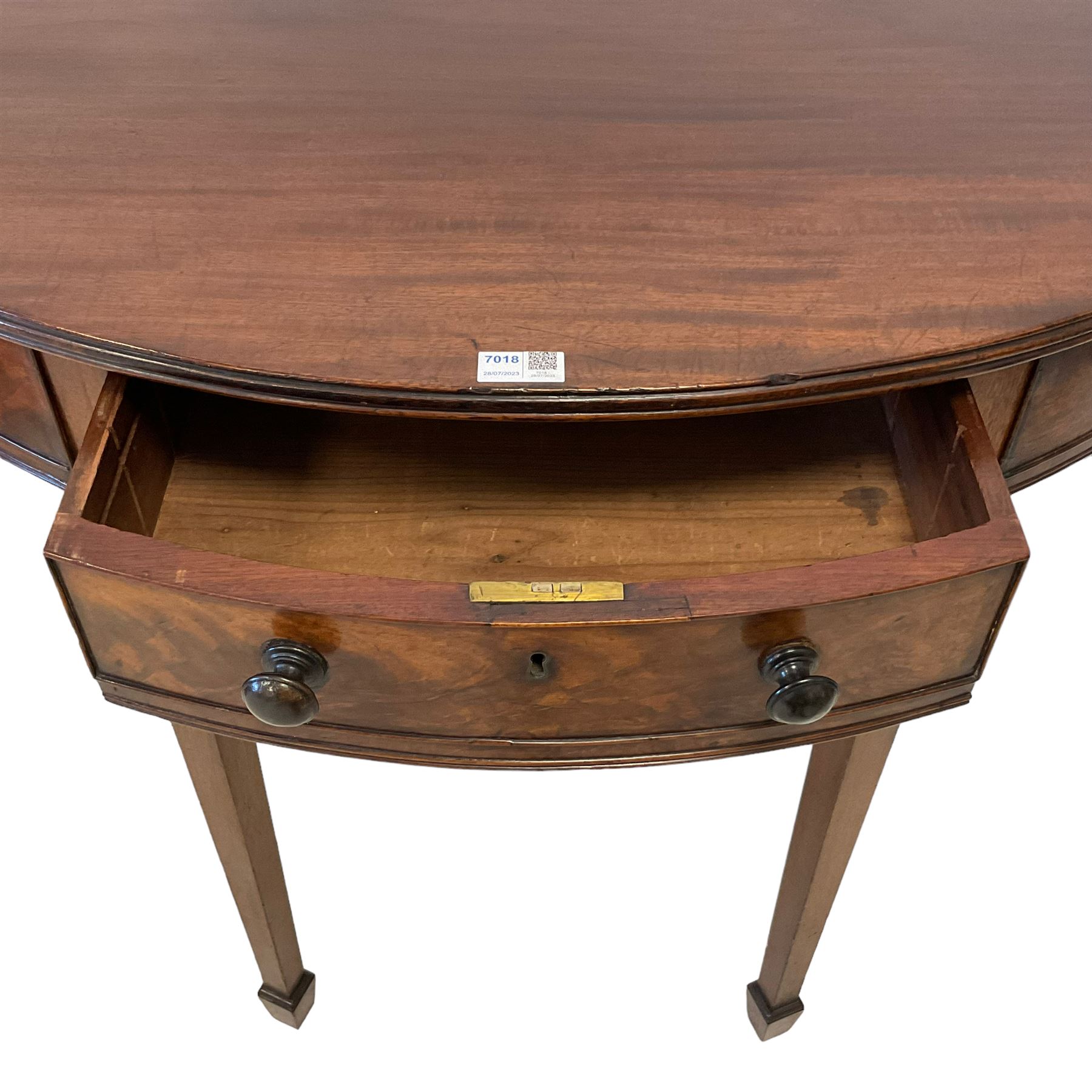 19th century mahogany demi-lune side or console table, reeded edge over central frieze drawer flanked by two hinged drawers with cock-beaded facias and turned handles, raised on square tapering supports with spade feet, the rear supports and feet chamfered in profile