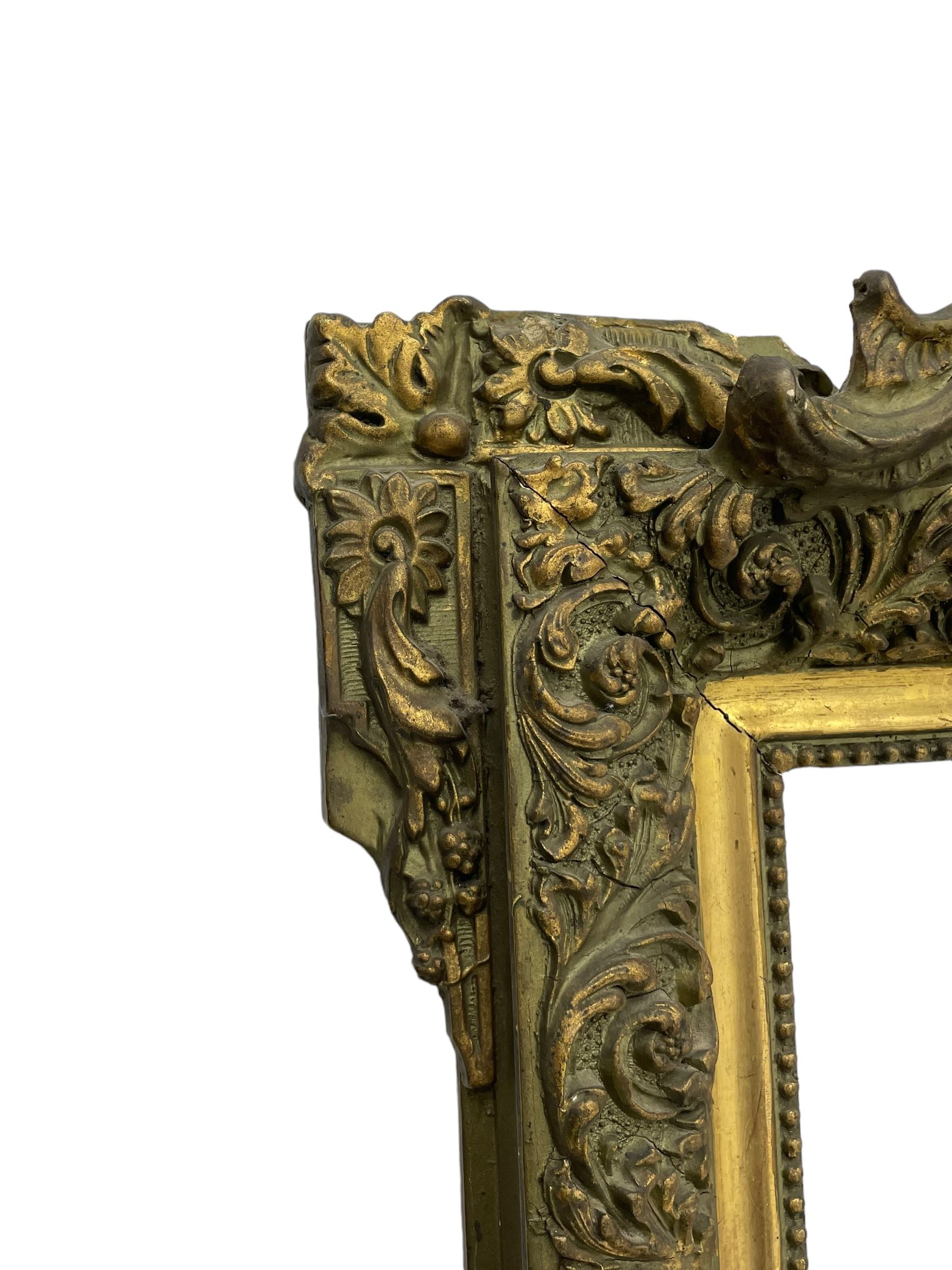 Victorian giltwood and gesso wall mirror, pierced shell cartouche pediment decorated with C-scrolls and curled leaves, moulded frame with curled acanthus leaf decoration and beaded inner slip, the corner brackets decorated with flower heads 