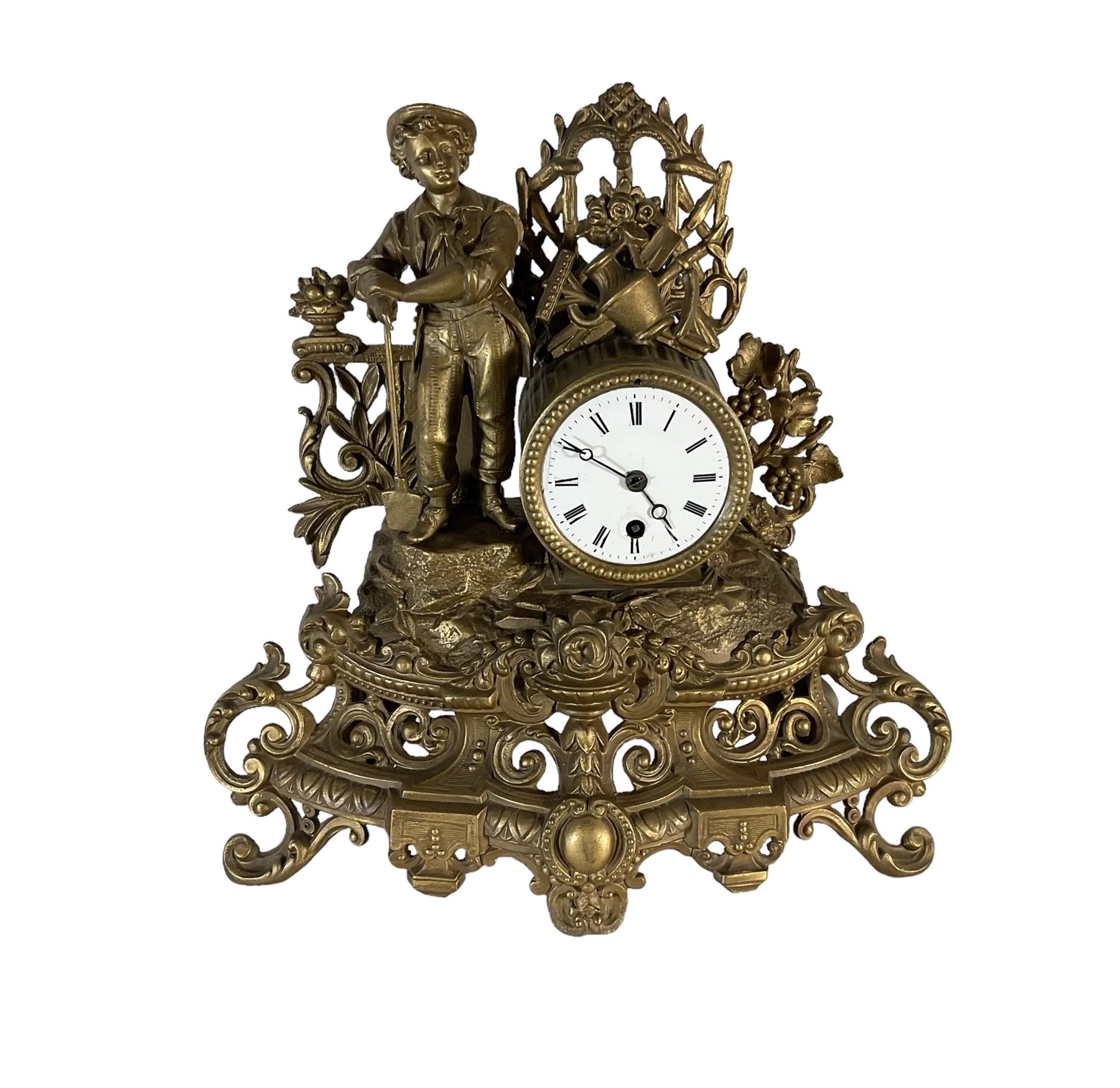 19th century - French gilt spelter 8-day timepiece mantle clock, with an ornate rococo case on splayed feet, drum movement with a cast figure of a gardener, flowers and gardening tools, white enamel dial with Roman numerals, minute markers and matching steel moon hands. With pendulum.   