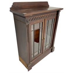 19th century mahogany display cabinet, rectangular top over frieze decorated with Vitruvian scroll mount, enclosed by two astragal glazed doors, the upright rails decorated with trailing bellflowers, on moulded plinth