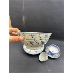 Early 19th century Chinese Tek Sing bowl, decorated with stylised blossoms, with 'Nagel Auctions' label to base, H6.5cm D15.5cm, together with a  Tek Sing similar saucer, D18cm, a Chinese tea bowl decorated in blue and red blossoming flowers, a Chinese blue and white saucer, and an English blue and white Willow pattern tea bowl, (5)